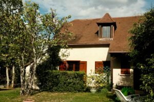 Quaint house in Terrasson-Lavilledieu, France, showcasing rustic charm and lush garden.